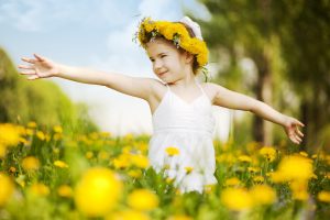 child in a flower field