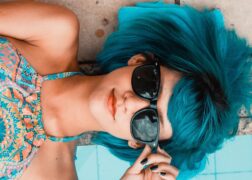 woman with blue hair and sunglasses