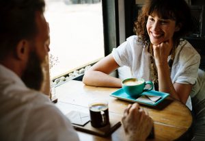 man and woman talking over coffee