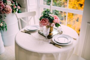 place setting for two on fine tablecloth