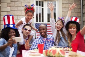 families in red white and blue around picnic table