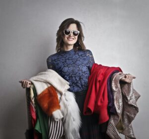 Woman holding clothing made of different fabrics