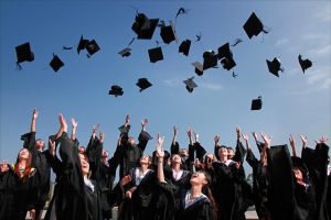 New grads throwing caps into air